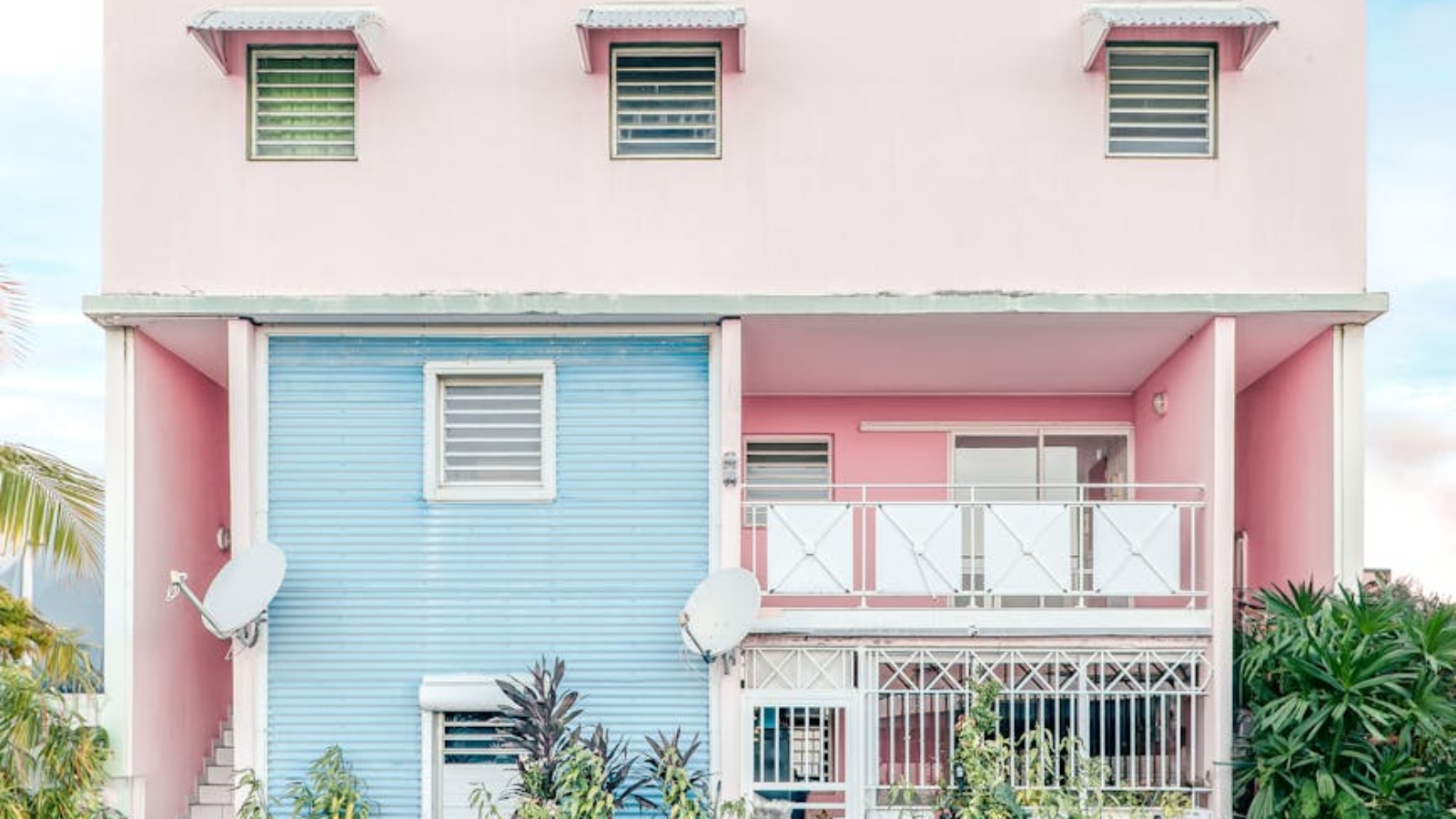 facade of a colorful house next to the street